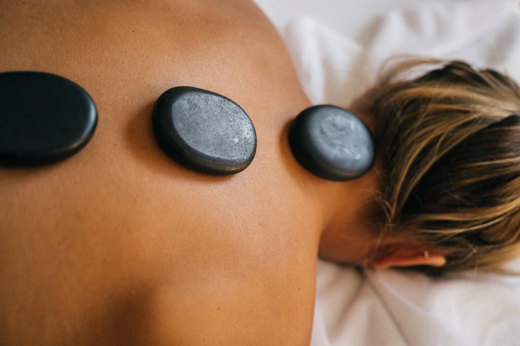 Peaceful spa setting with hot stone therapy promoting relaxation and relief.
